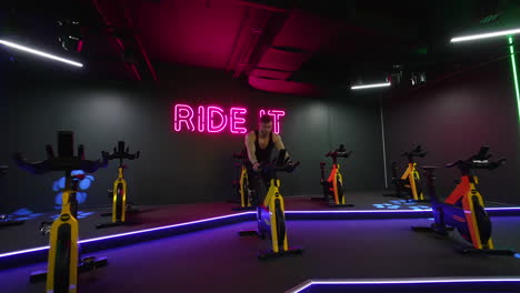 man training on spin bike. young man exercising legs doing cardio workout on cycling bike