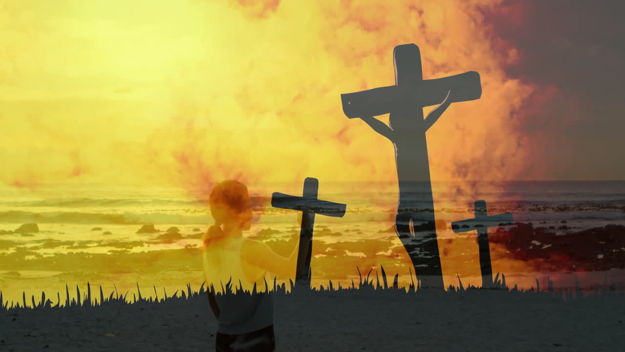 Praying person silhouetted against vibrant sunset, animation of crosses at beach
