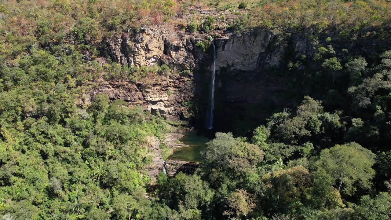 aerial video of waterfall in Chapada dos Veadeiros, Cachoeira Simão Correia, Alto Paraíso de Goiás, green water, sunny day