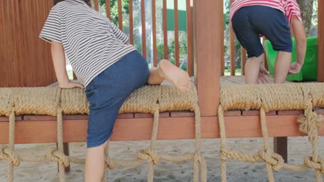 active little sisters are running in the outdoor playground in the park. happy child girls smiling and laughing on children playground. the concept of play is learning in childhood.