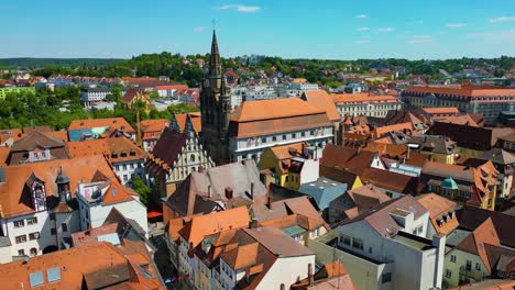 4k aerial drone video of the historic st. johannis church in the old town area of downtown ansbach, germany