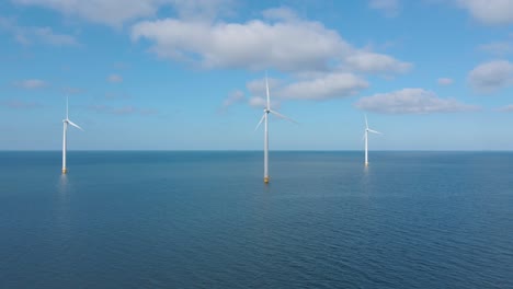 huge windmill turbines, offshore windmill farm in the ocean westermeerwind park , windmills isolated at sea on a beautiful bright day netherlands flevoland noordoostpolder