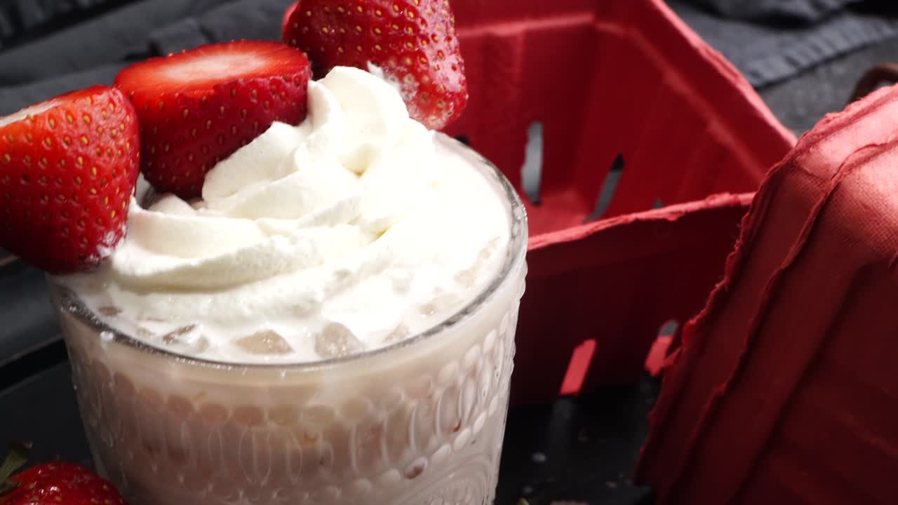 Pink cocktail drink with strawberry liqueur, vanilla vodka and cream. Party drink with strawberries. Fruit cocktail with fresh strawberries as a garnish. Cold and refreshing