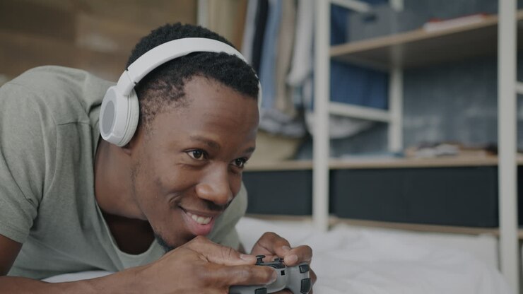 Man Playing Video Games in His Bedroom
