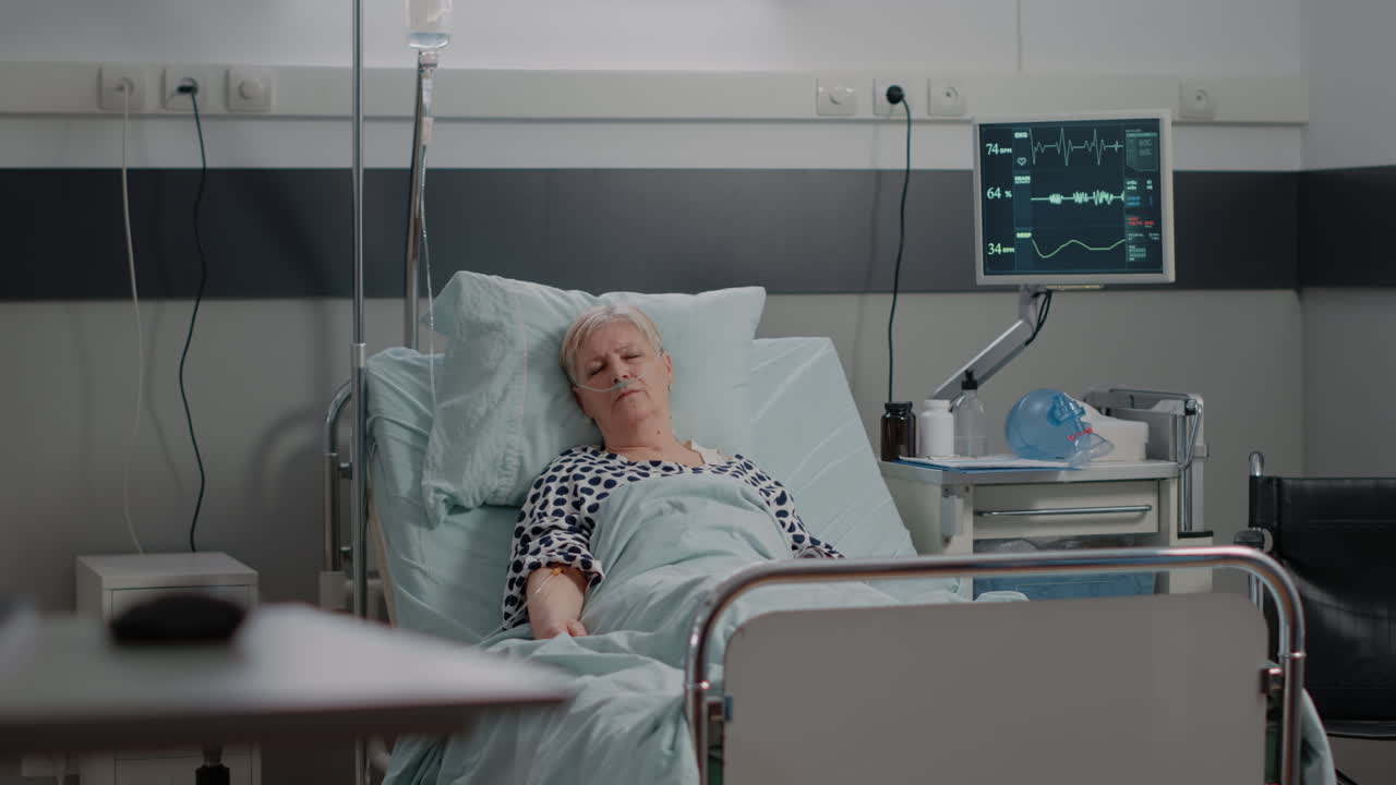 Aged patient with illness resting in hospital ward bed