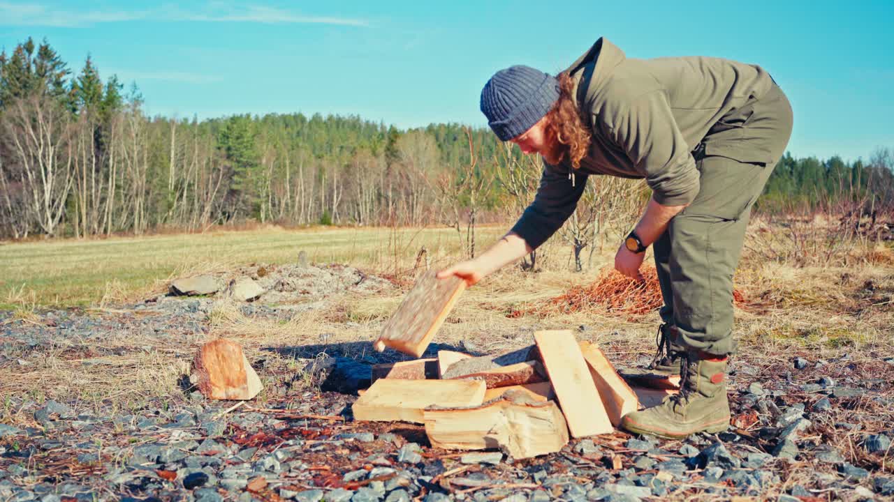 A Man is Getting Ready to Burn Freshly Cut Firewood - Close Up