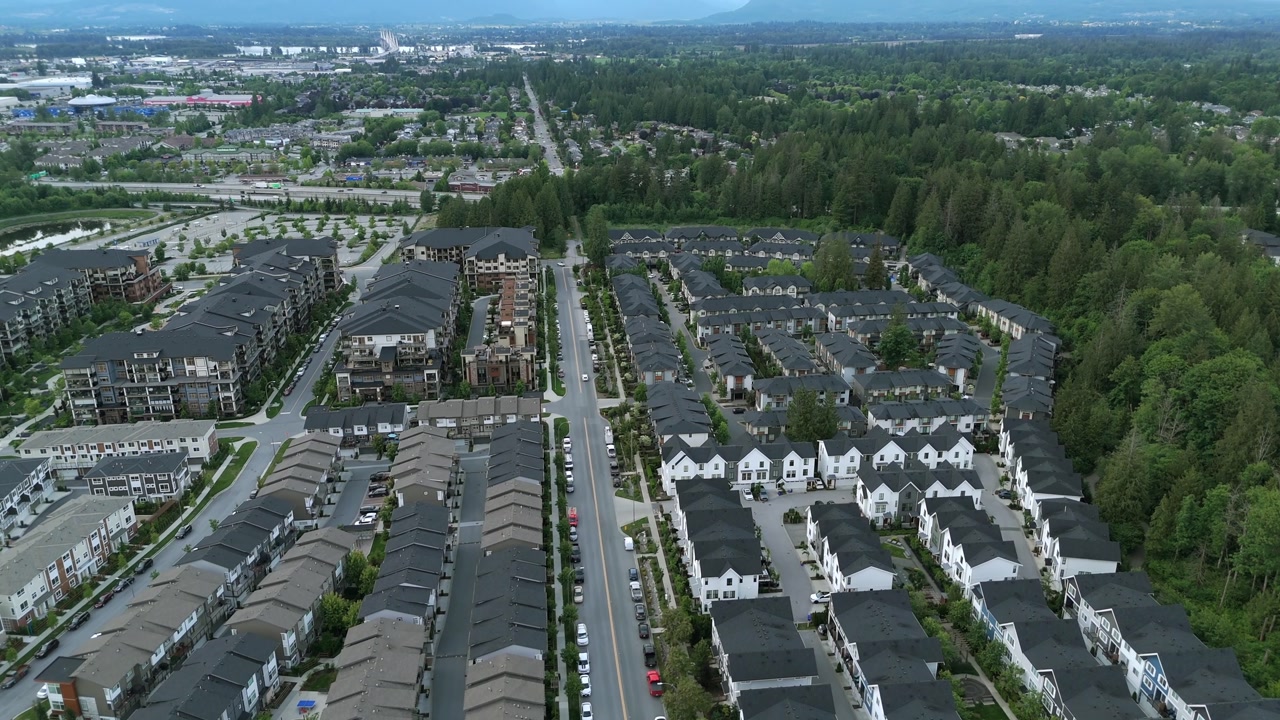 Aerial View Of Roundabout Road Across Suburban Townhouses In Langley Township, British Columbia, Canada.
