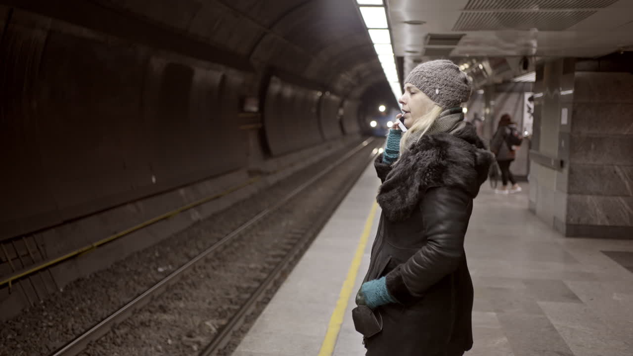 Person Waiting for a Train on a Dark Subway Platform