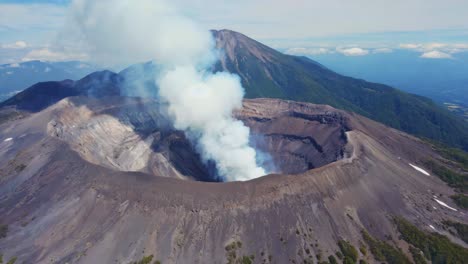 volcanic crater with smoke rising
