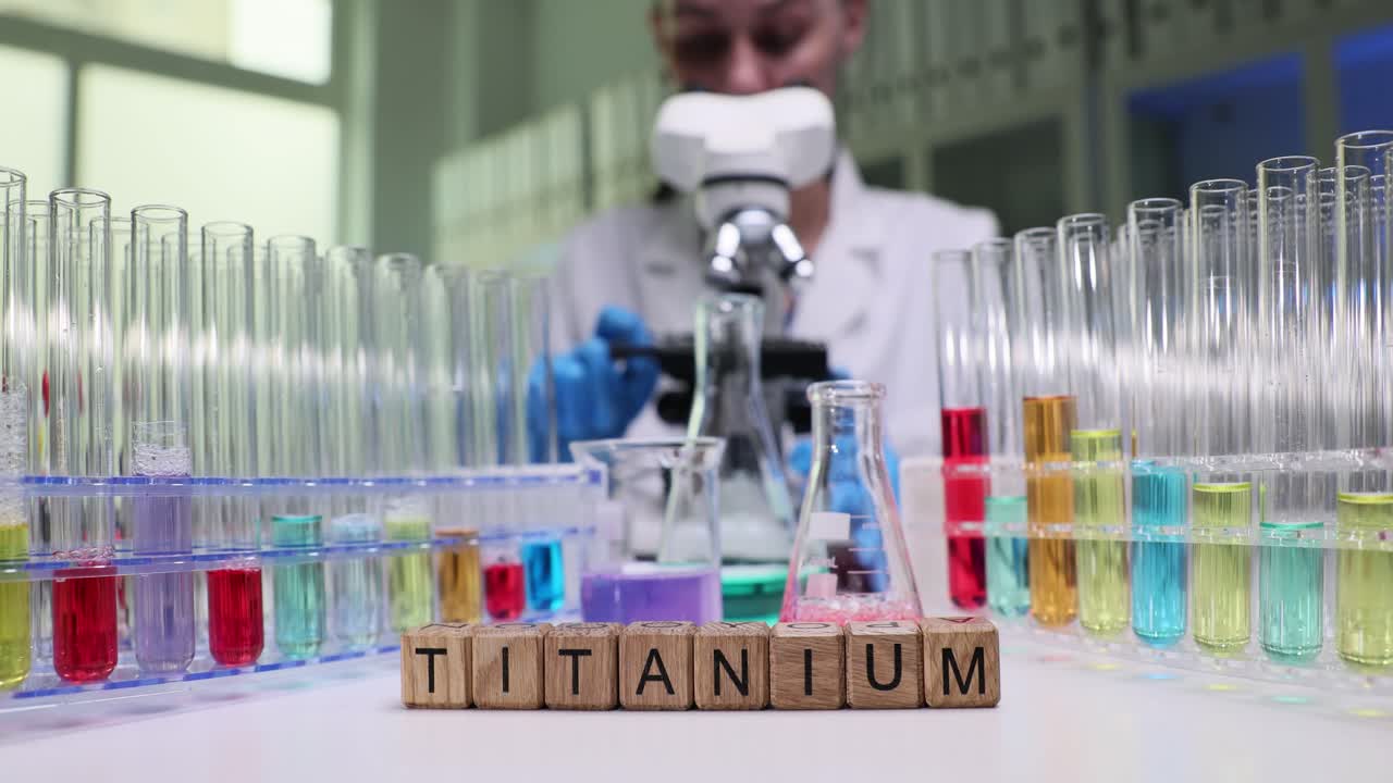 A person conducting research in a chemistry lab with titanium
