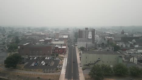 Aerial-drone-view-of-town-covered-in-smog-and-haze