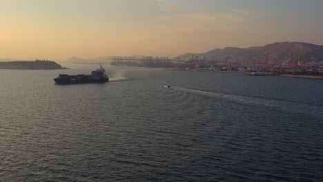 aerial - merchant ship sailing at sunset