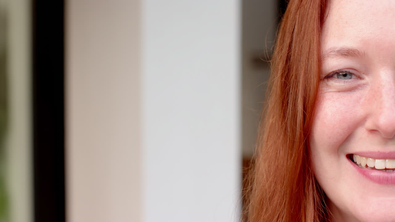 Red-haired woman with friends at home, laughing and having fun together, copy space