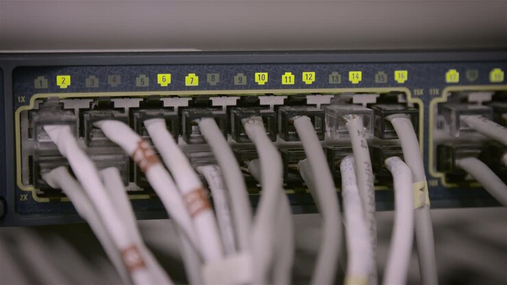 Computer cables are plugged into a hub in a data center