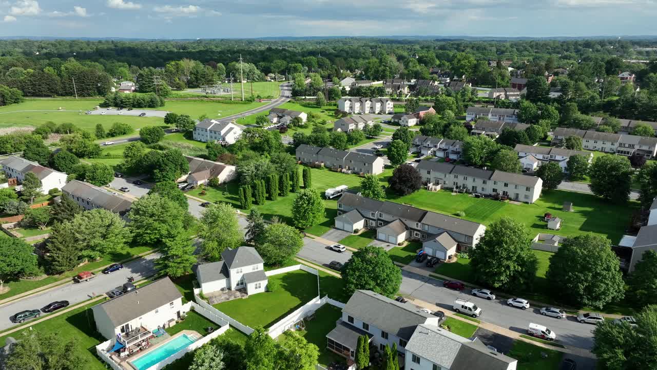 Aerial view of residential neighborhood in Lancaster, PA with well-maintained homes and lush green lawns. peaceful suburban atmosphere, perfect for family living and community life. Aerial wide shot.