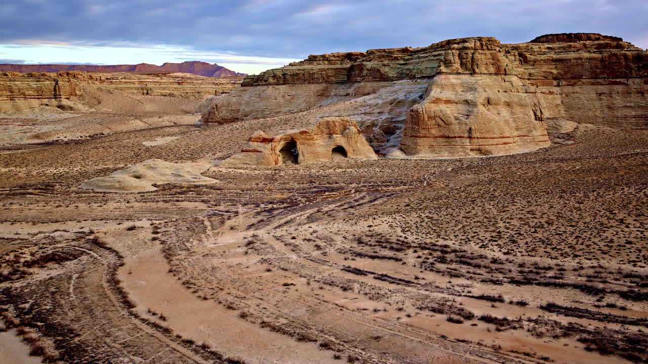 A cinematic aerial perspective revealing the untouched beauty of the Lake Powell desert landscape.
