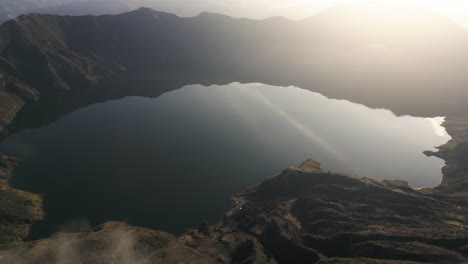 aerial drone above quilotoa crater ecuatorian water volcano, indigenous highland peak, golden sunlight in travel destination, ecuador, south america