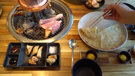 traditional korean barbecue table with several popular dishes in restaurant