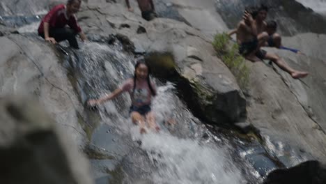 children playing at a waterfall