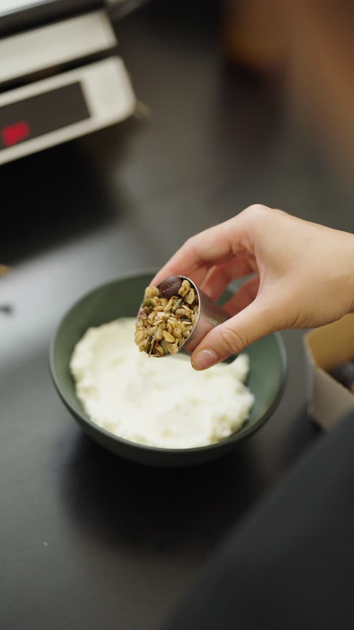 Making a healthy granola and yogurt breakfast bowl