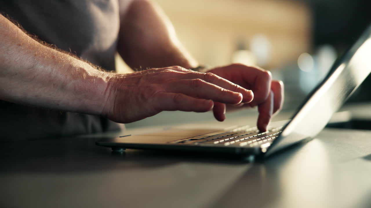 Close-up of Hands Typing on Laptop Keyboard