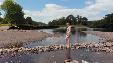 Young-woman-walking-near-a-river-4k