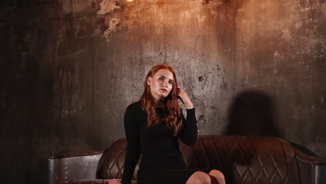 woman in a black dress on a vintage sofa