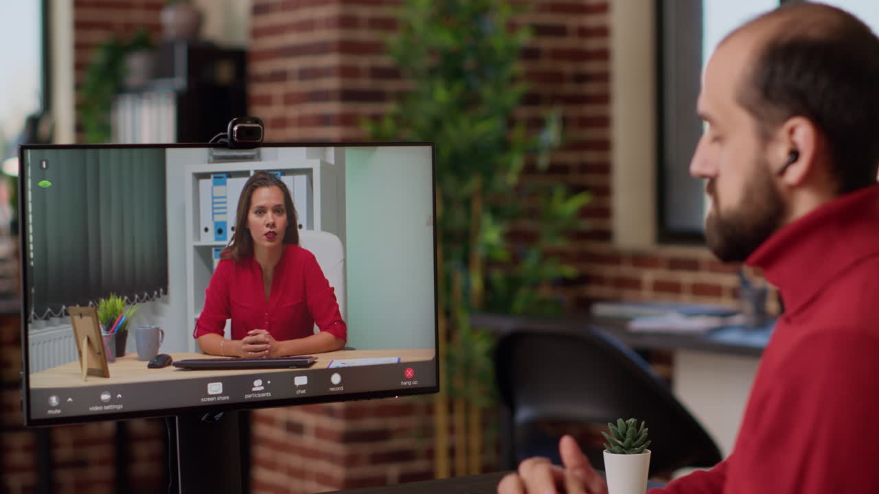 Male employee attending remote videoconference meeting