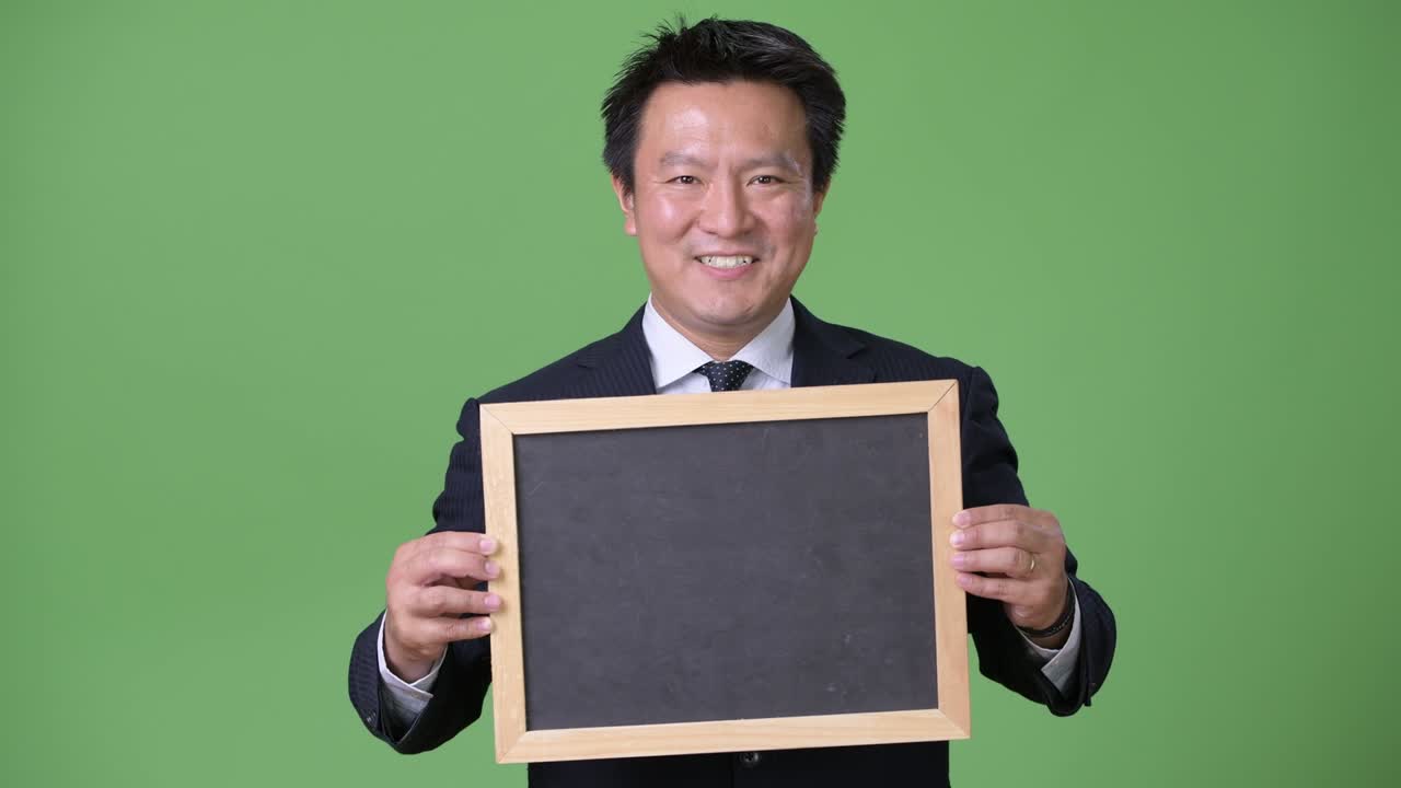 녹색 배경에 성숙한 일본 사업가