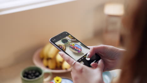 hand, phone and photograph of breakfast