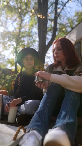 two friends enjoying a conversation outdoors in autumn