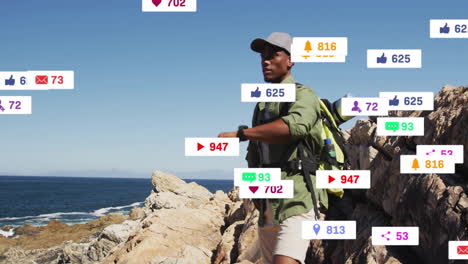 hiking on rocky coast, man viewing animation of social media notifications