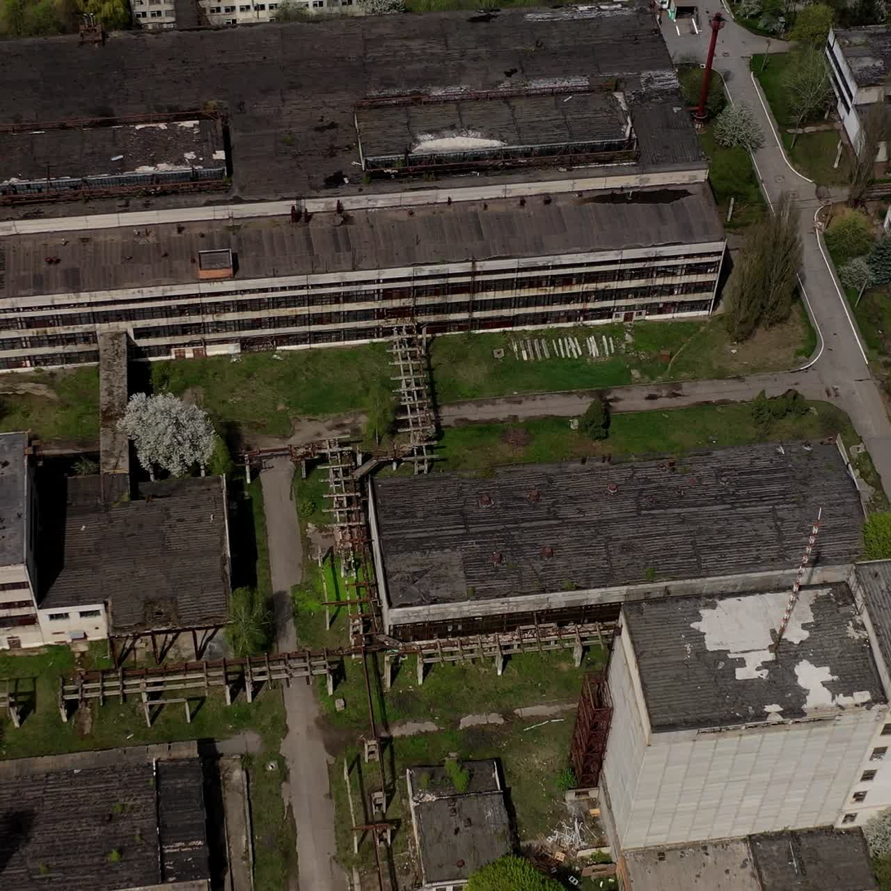 Big abandoned territory of an old factory. Ruined buildings of old industrial plant. Aerial view