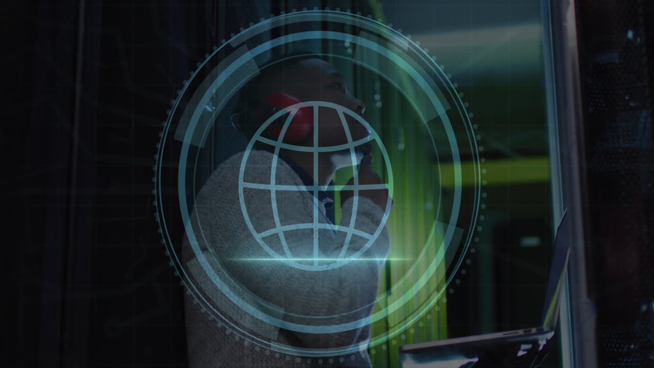 Animation of web globe icon over african american male engineer using laptop at server room