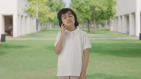 confused indian boy thinking about something in park