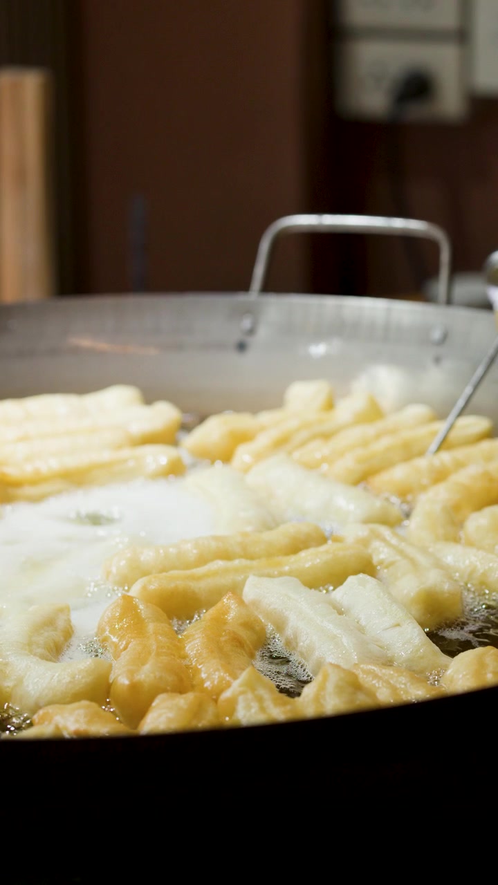 Deep Frying Youtiao Dough Sticks in a Large Wok