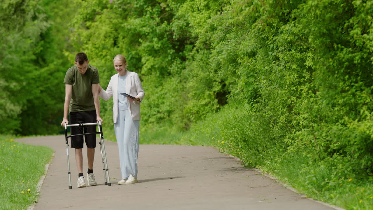 Patient receiving assistance while walking in a park