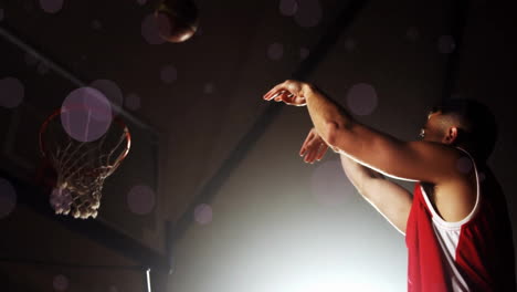 animation of caucasian basketball player throwing ball and spots of light on black background