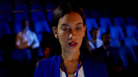 businesswoman attending business seminar in auditorium 4k