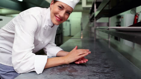 chef feliz poniendo hojas de menta en el plato de postre