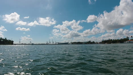 view from the starboard side of a small watercraft traveling the waterways of miami florida