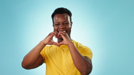 Face,-heart-and-hands-of-happy-black-man-in-studio