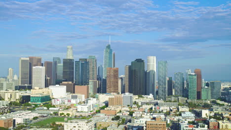 drone left to right establish panoramic los angeles california skyscraper buildings, dramatic grey cloudy sky