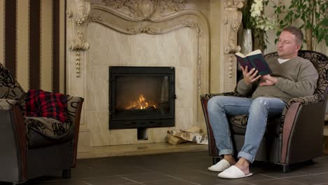 man reading by the fireplace