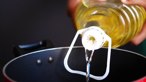 pouring oil into a pan