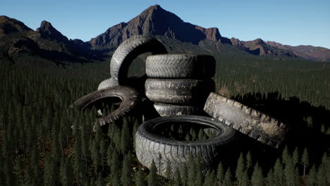 concept-of-environmental-pollution-with-big-old-tires-in-mountain-forest