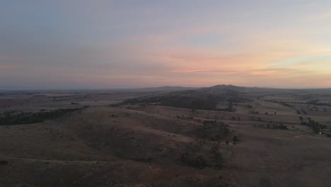 Aerial-over-beautiful-natural-landscape,-Appila-springs-fields-at-dusk-lights,-Australia