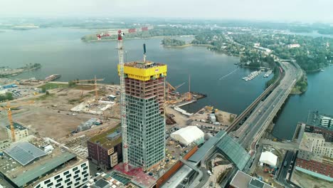 orbiting aerial shot of a tall building under construction