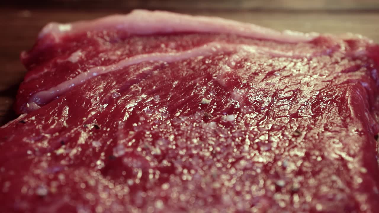 Mixed pepper and spices on the raw meat steak