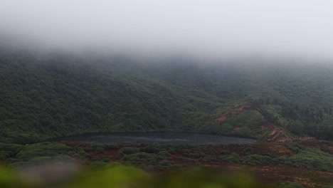 Time-lapse-of-a-lake-in-the-mountains-with-low-clouds-passing-by